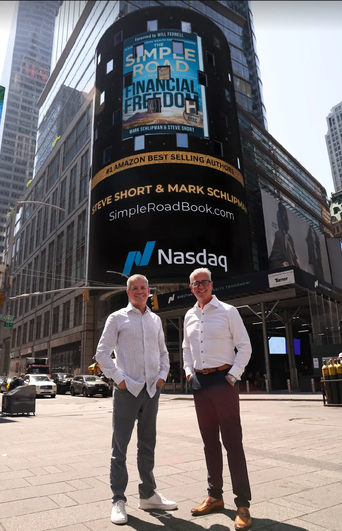 Steve Short and Mark Schlipman in Times Square with a book billboard behind them
